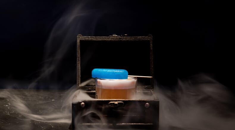 The daring and dramatic Breaking Bad Pisco Punch from Puttshack has a blue popsicle garnish and comes smoked with hemp smoke.
(Courtesy of Puttshack)