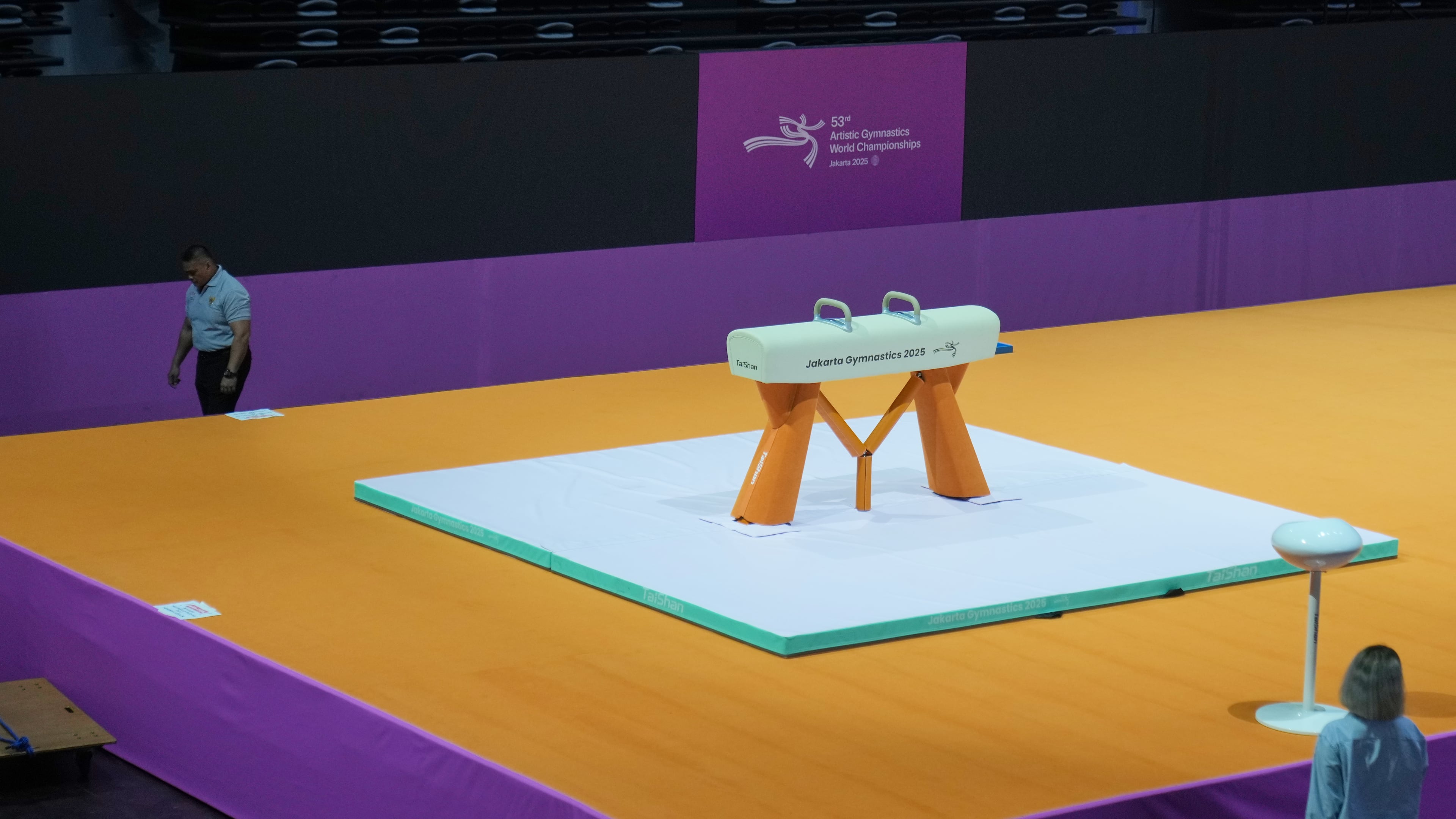 A security guard walks past a pommel horse at the venue prepared for the Artistic Gymnastics World Championships at Indonesia Arena in Jakarta, Indonesia, Friday, Oct. 10, 2025. (AP Photo/Dita Alangkara)