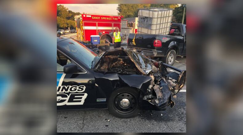 A Sandy Springs police officer was taken to the hospital after his vehicle was struck and damaged by a driver Thursday afternoon, authorities said.