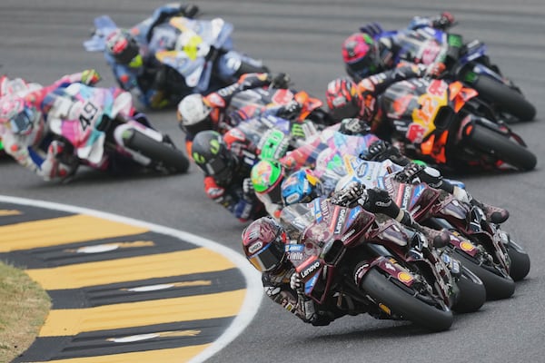 Spain's rider Marc Marquez of the Ducati Lenovo Team steers his motorcycle followed by Italian rider Francesco Bagnaia of the Ducati Lenovo Team and Spain's rider Alex Marquez of the BK8 Gresini Racing MotoGP during the MotoGP race of the Grand Prix of Italy at the Mugello circuit in Scarperia, Italy, Sunday, June 22, 2025. (AP Photo/Antonio Calanni)