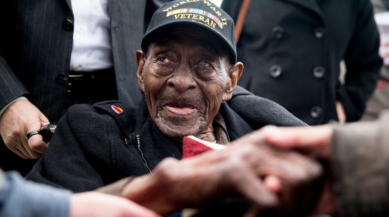 FILE - In this Dec. 7, 2015 file photo, Frank Levingston Jr., of Lake Charles, La., is greeted by visitors following a wreath laying ceremony to mark the anniversary of Pearl Harbor at the World War II Memorial in Washington. Levingston, a 110-year-old veteran who served in World War II has died, on Tuesday, May 3, 2016. (AP Photo/Andrew Harnik)