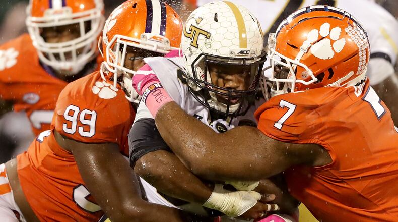 Clemson's Clelin Ferrell (99) and Austin Bryant (7) gang up on Tech running back KirVonte Benson Saturday at Memorial Stadium.  (Streeter Lecka/Getty Images)