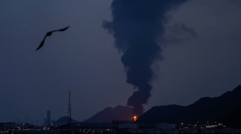 Large fire and plume of smoke is visible after, according to the authorities, debris of an Iranian intercepted drone hit the Fujairah oil facility, in Fujairah, United Arab Emirates, Tuesday, March 3, 2026. (AP Photo/Altaf Qadri)