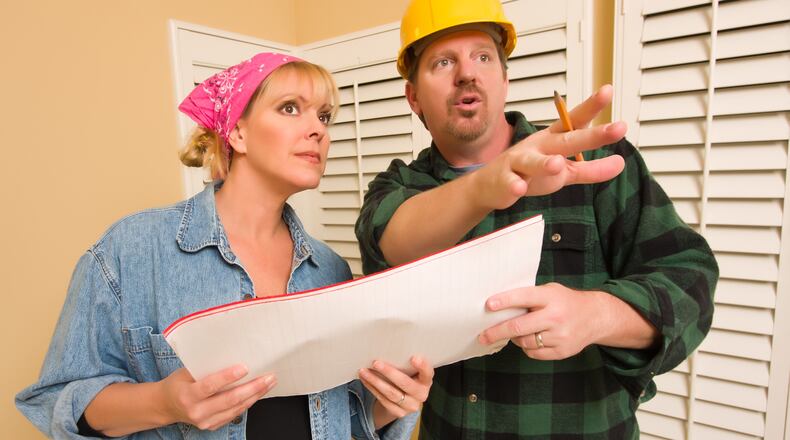 Avoid miscommunication with a written contract that clearly spells out the full scope of your project — all the way down to specifics like paint colors. (Dreamstime)