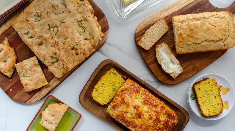 These quick breads can be made, baked and on the table in under an hour: (from left) Quick Bread Focaccia, Savory Yogurt Loaf and Beer Bread. (Virginia Willis for The Atlanta Journal-Constitution)