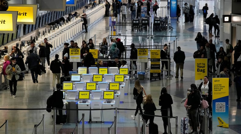 FILE - People check into their flights at Harry Reid International Airport, Jan. 11, 2023, in Las Vegas. (AP Photo/John Locher, File)