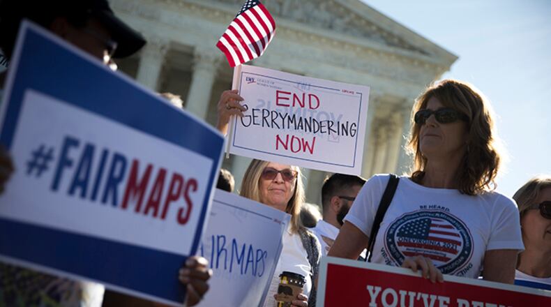 Demonstrators outside the U.S. Supreme Court building as justices heard arguments in a key gerrymandering case, on Capitol Hill in Washington, Oct. 3, 2017. On Tuesday, lawyers for the state of Wisconsin urged the justices to reject a challenge to that state's redistricting map, drawn by the Republican-controlled government.
