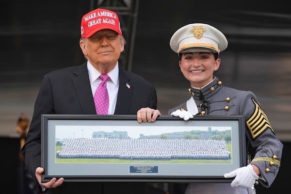 Class President Katherine LaReau, right, poses with President Donald Trump as she presents the class gift to Trump at the United States Military Academy commencement ceremonies in West Point, N.Y., Saturday, May 24, 2025. (AP Photo/Manuel Balce Ceneta)