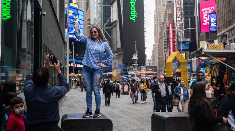 Tourists take photos in Times Square on April 29, 2021. People were injured in a shooting incident on Saturday, May 8, 2021, in the popular New York City spot. (Victor J. Blue/The New York Times)