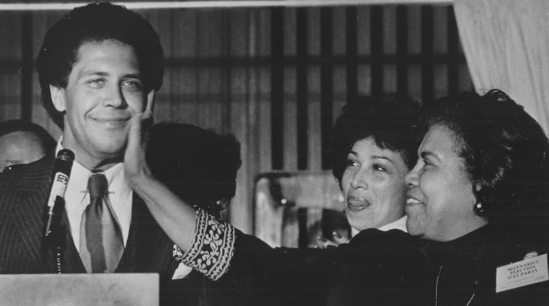 1970s - ATLANTA, GA -- Maynard Jackson, Atlanta's first black mayor, and his mother (giving a love pat to his face). (George A. Clark/AJC staff)
