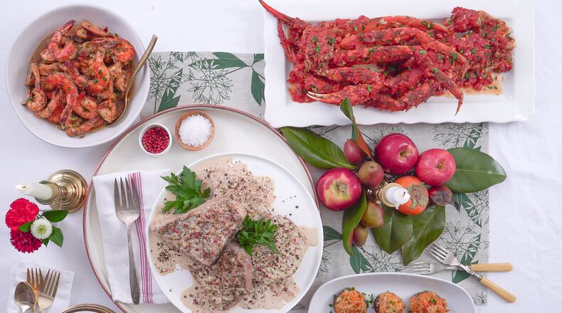 Making smart choices at the fish counter can make this year’s holiday seafood dishes, like Swordfish Au Poivre (center), Baked Honey Ginger Shrimp (top left), Crab Legs with Spicy Garlic Tomato Sauce (top right) and Crab Stuffed Mushrooms (bottom left), impressive and reasonably affordable. (Chadwick Boyd for The Atlanta Journal-Constitution)
