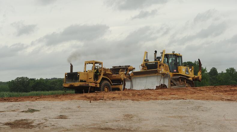 May 3, 2013 - Fayetteville: A heavy equipment operator uses a bulldozer to prepare farm land for the construction of Pinewood Studios on Friday, May 3, 2013 in Fayetteville, GA. Once construction is complete it will be the largest movie studio east of the Mississippi River. JCRAWFORD@AJC.COM