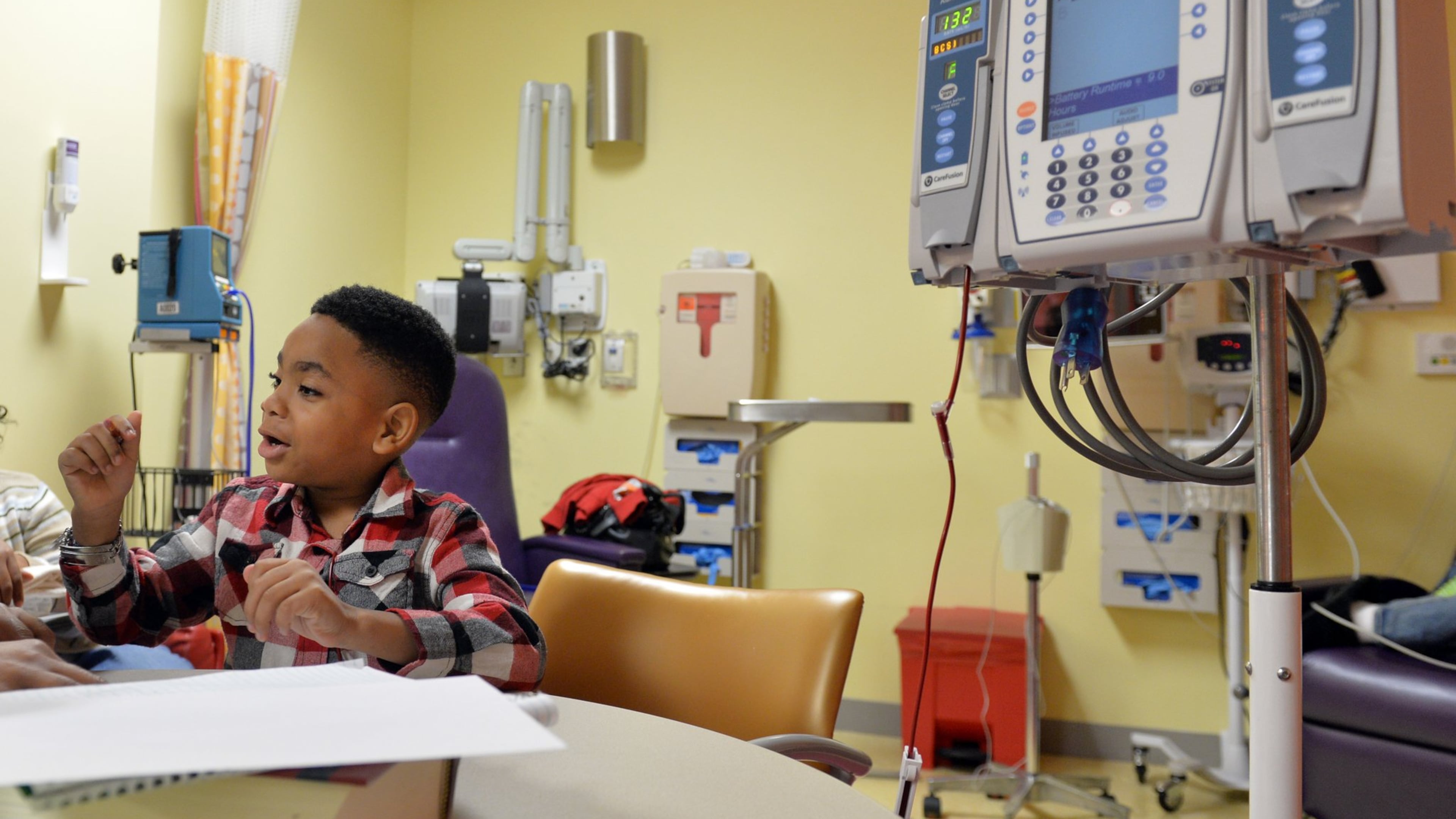 In this 2014 file photo, a 6-year-old Antwon Thornton works on a math worksheet while receiving a transfusion at Children’s Healthcare of Atlanta at Hughes Spalding. Thornton, who suffers from sickle cell disease, had his first stroke just before his second birthday. (Brant Sanderlin/AJC)