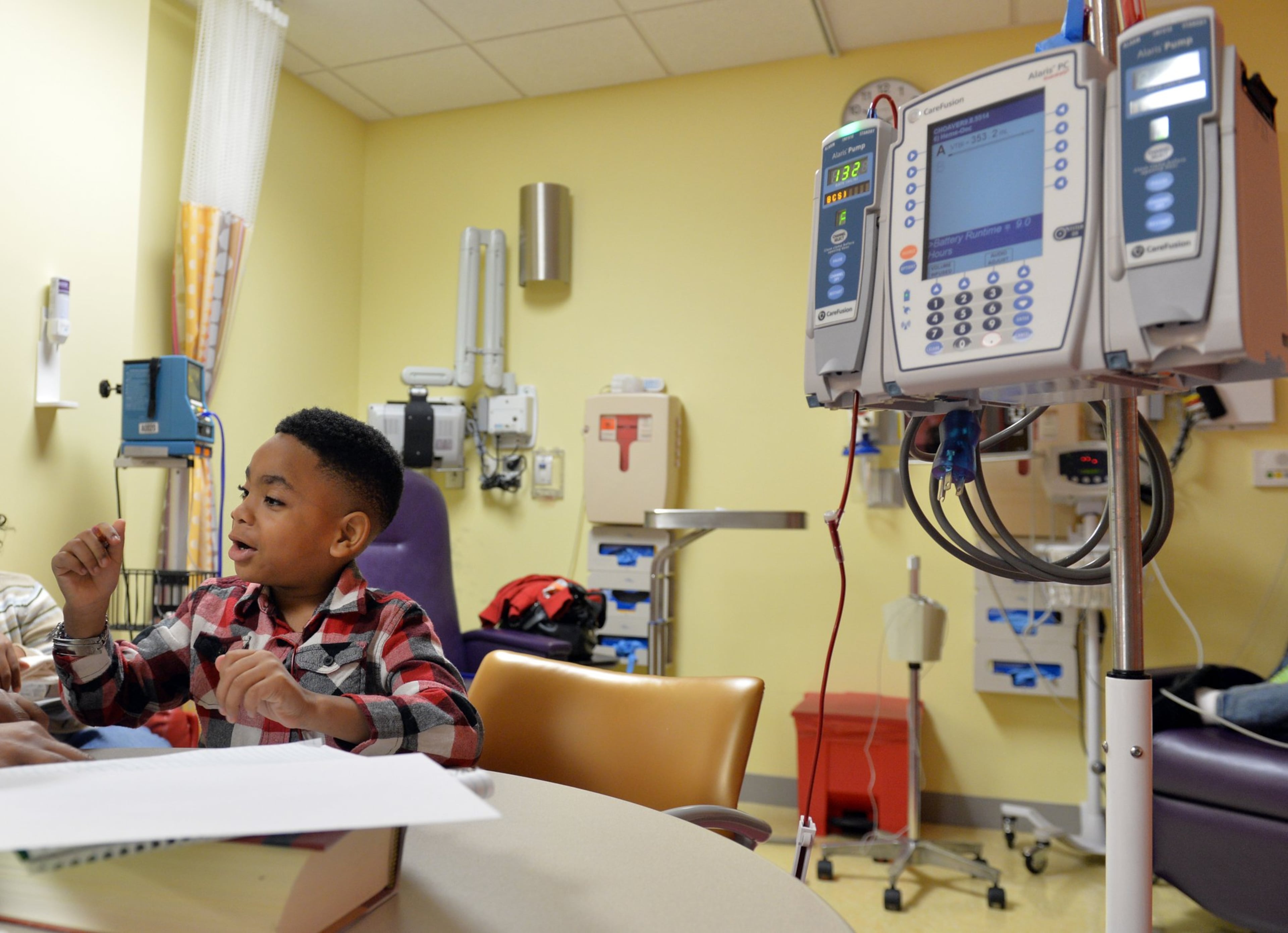 In this 2014 file photo, a 6-year-old Antwon Thornton works on a math worksheet while receiving a transfusion at Children’s Healthcare of Atlanta at Hughes Spalding. Thornton, who suffers from sickle cell disease, had his first stroke just before his second birthday. (Brant Sanderlin/AJC)