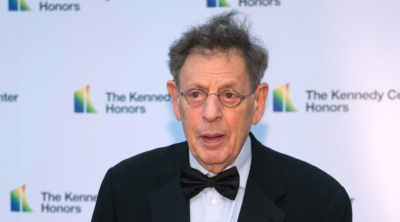FILE - 2018 Kennedy Center Honoree composer Philip Glass arrives at the State Department for the Kennedy Center Honors State Department Dinner, Dec. 1, 2018, in Washington. (AP Photo/Kevin Wolf, File)