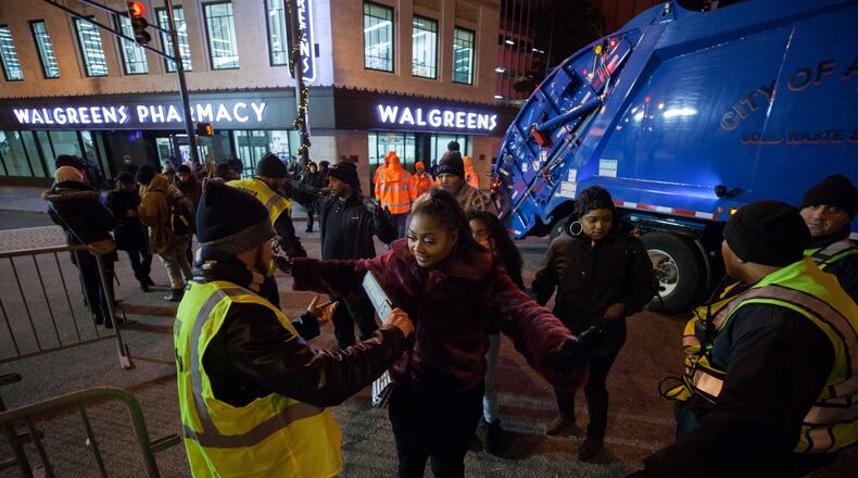 Atlanta police sent mixed signals about whether lawful gun owners were permitted to bring concealed weapons to the Peach Drop. Attendees went through a security checkpoints to gain access to the event. BRANDEN CAMP / SPECIAL