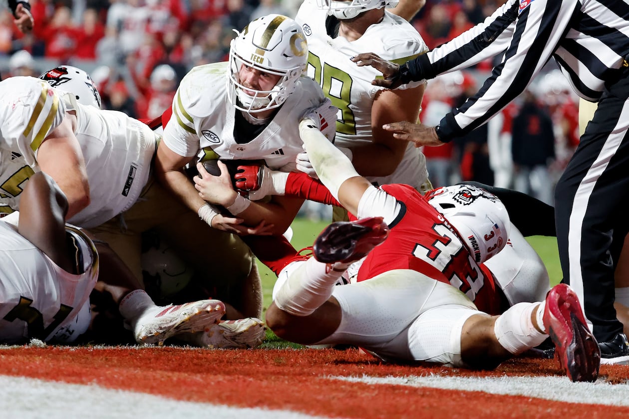 Georgia Tech quarterback Haynes King (center) is prevented from reaching the end zone by North Carolina State linebacker Kenny Soares Jr. (right, on ground) during the second half Saturday, Nov. 1, 2025, in Raleigh, N.C. (Karl DeBlaker/AP)