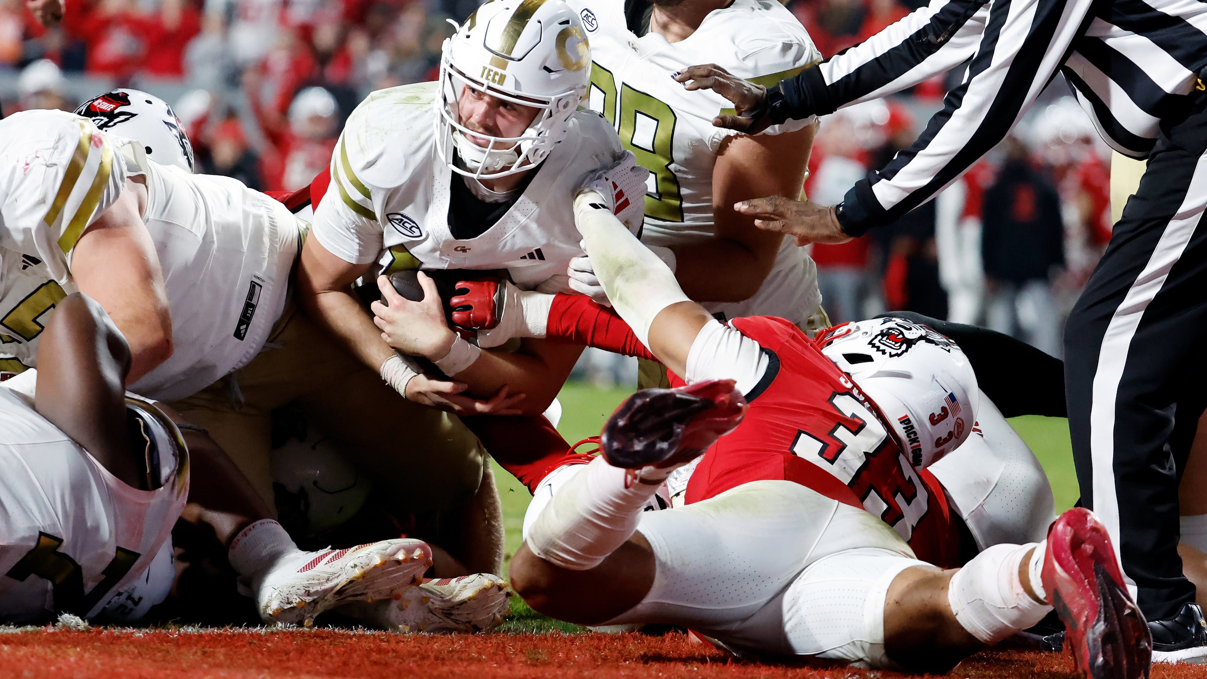 Georgia Tech quarterback Haynes King (center) is prevented from reaching the end zone by North Carolina State linebacker Kenny Soares Jr. (right, on ground) during the second half Saturday, Nov. 1, 2025, in Raleigh, N.C. (Karl DeBlaker/AP)