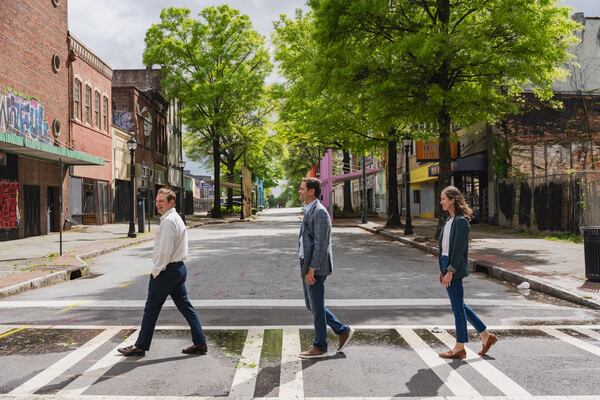 Jon Birdsong (from left) and David Cummings tour their properties with April Stammel on Thursday, April 11, 2024, in downtown Atlanta. (Jason Allen/AJC)