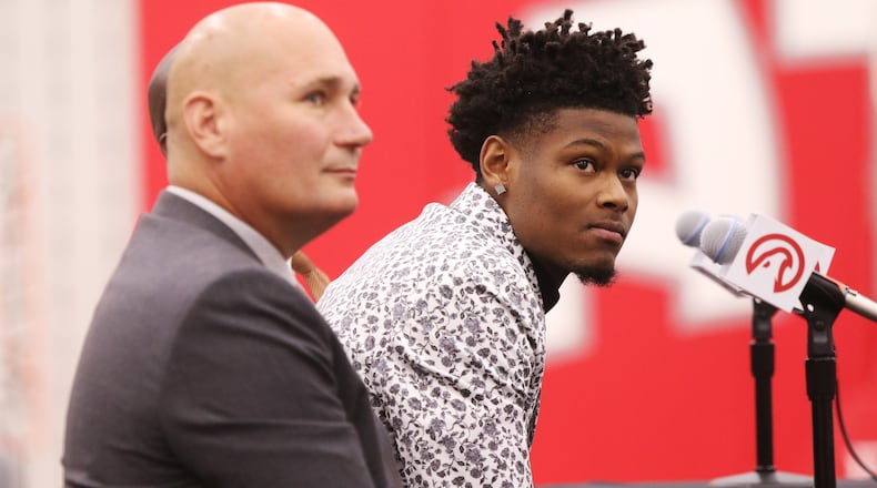 Atlanta Hawks General Manager Travis Schlenk and Hawks 2019 draft pick Cam Reddish listen to a question at Reddish's introductory press conference at the Hawks practice facility, in the Emory Sports Medicine Complex, in Brookhaven, Georgia on Monday June 24, 2019. Reddish was selected by the Atlanta Hawks in the 2019 NBA Draft on June 20, 2019, and was the 10th overall pick. Reddish previously played small forward/shooting guard for the Duke University Blue Devils. Christina Matacotta/CHRISTINA.MATACOTTA@AJC.COM