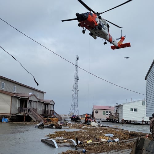 A helicopter responds after the remnant storms of Typhoon Halong devastated Kipnuk, Alaska, on Sunday, Oct. 12, 2025. (John Roland Carl II via AP)