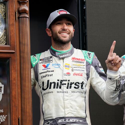 Chase Elliott poses with the trophy in Victory Lane after winning a NASCAR Cup Series auto race in Martinsville, Va., Sunday, March 29, 2026. (AP Photo/Chuck Burton)