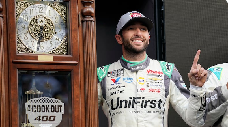 Chase Elliott poses with the trophy in Victory Lane after winning a NASCAR Cup Series auto race in Martinsville, Va., Sunday, March 29, 2026. (AP Photo/Chuck Burton)