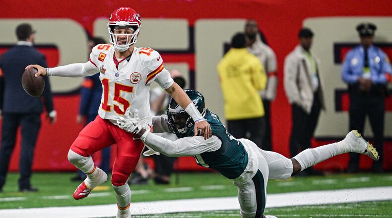 Kansas City Chiefs quarterback Patrick Mahomes (15) is grabbed in the third quarter by Philadelphia Eagles linebacker Josh Sweat (19) during Super Bowl LIX on Sunday, Feb. 9, 2025, in New Orleans. (Tammy Ljungblad/The Kansas City Star/TNS)