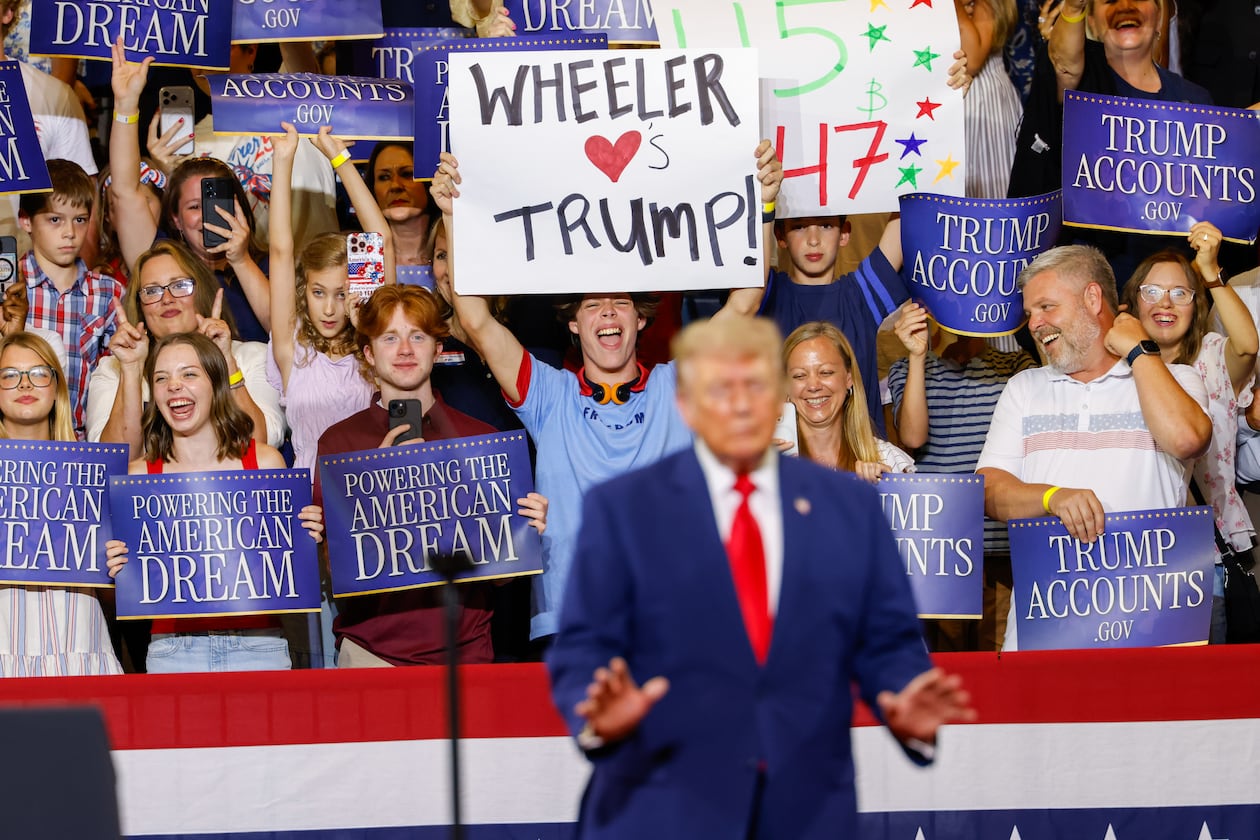 A support holds a sign that says “Wheeler Loves Trump” as President Donald Trump speaks at Wheeler High School in Marietta on July 22, 2026. (Arvin Temkar/AJC)