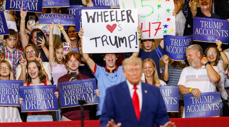 A support holds a sign that says “Wheeler Loves Trump” as President Donald Trump speaks at Wheeler High School in Marietta on July 22, 2026. (Arvin Temkar/AJC)