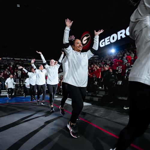 Georgia freshman gymnast CaMarah Williams (center) — pictured before the Bulldogs' meet against Auburn in February — is the team's leader in performances of 9.900 or higher this season with 19. (Tony Walsh/UGAAA)