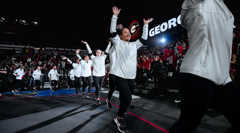 Georgia freshman gymnast CaMarah Williams (center) — pictured before the Bulldogs' meet against Auburn in February — is the team's leader in performances of 9.900 or higher this season with 19. (Tony Walsh/UGAAA)