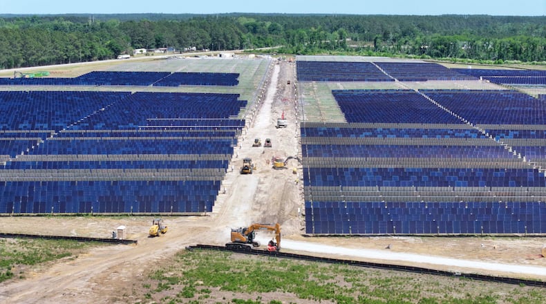 An aerial image depicts multiple heavy machinery working on a large site in Bacon County, where Silicon Ranch is constructing one of Georgia’s largest solar farms, in one of the state’s smallest counties, on Tuesday, April 21, 2026. The project faces opposition from residents and farmers, who say it is altering their way of life. (Miguel Martinez/AJC)