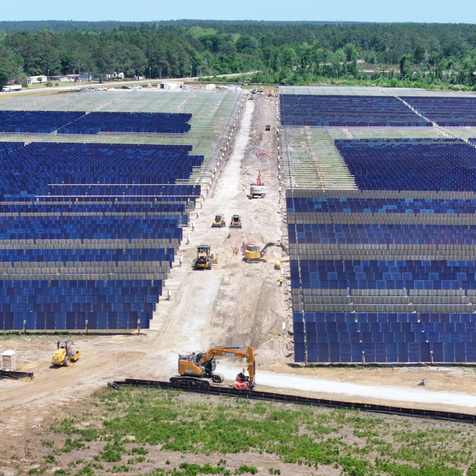 An aerial image depicts multiple heavy machinery working on a large site in Bacon County, where Silicon Ranch is constructing one of Georgia’s largest solar farms, in one of the state’s smallest counties, on Tuesday, April 21, 2026. The project faces opposition from residents and farmers, who say it is altering their way of life. (Miguel Martinez/AJC)