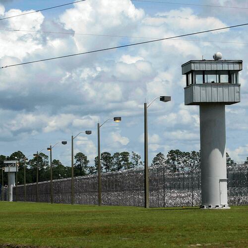 FILE - Fence and towers at the Baker Correctional Institution, Sanderson, Fla., Thursday, Aug. 14, 2025. (AP Photo/Gary McCullough, File)