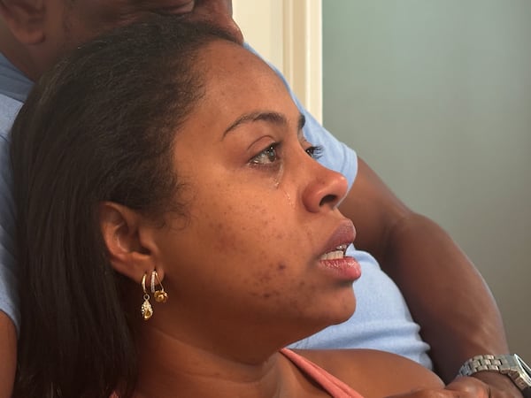 Reginald Wesley consoles Tiffany Roache inside his Conyers home after her daughter's death. “I feel like I failed her. As a parent, you’re supposed to keep your children safe,” Tiffany said, breaking down in tears. (David Aaro/AJC)