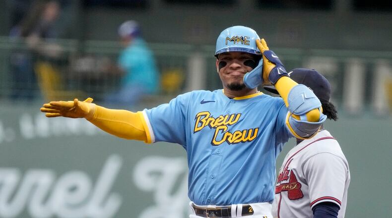 Milwaukee Brewers' William Contreras reacts after hitting an RBI double during the first inning of a baseball game against the Atlanta Braves Friday, July 21, 2023, in Milwaukee. (AP Photo/Morry Gash)