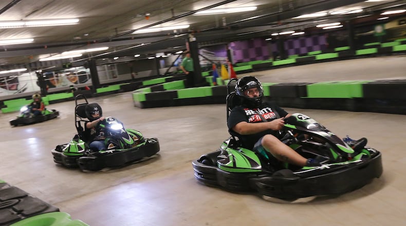 Sure, you can race cars in video games at home, but how about something a little more real? Kadri Ozee leads Holly Pourhassan down the straight away at Andretti Indoor Karting and Games in Marietta during a recent visit. CURTIS COMPTON / CCOMPTON@AJC.COM