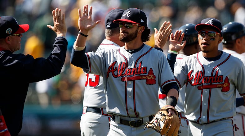 Dansby Swanson celebrates with Atlanta Braves teammates after a 4-3 win against the Oakland Athletics at the Oakland Coliseum on July 1, 2017, in Oakland.