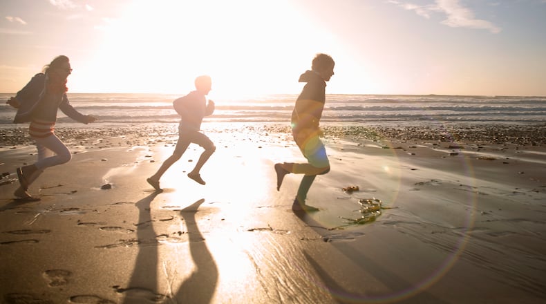 Children running on beach (stock photo)