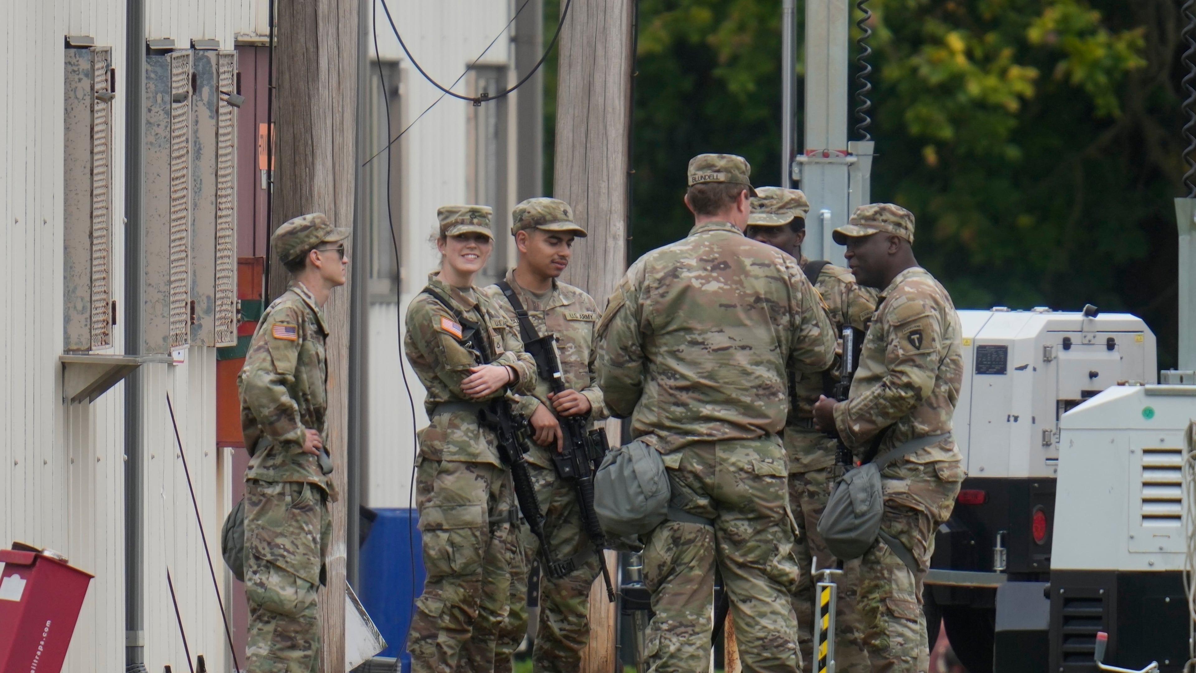 Military personnel in uniform, with the Texas National Guard patch on, are seen at the U.S. Army Reserve Center, Tuesday, Oct. 7, 2025, in Elwood, Ill., a suburb of Chicago. (AP Photo/Erin Hooley)