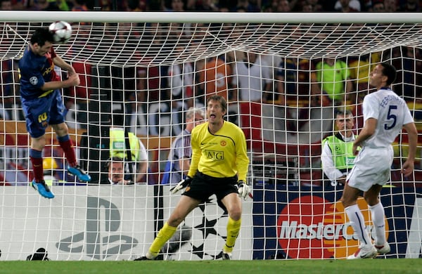 FILE - Barcelona's Lionel Messi, left, scores on a header during the UEFA Champions League final soccer match between Manchester United and Barcelona in Rome, May 27, 2009. (AP Photo/Gregorio Borgia, File)