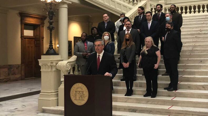 Georgia Secretary of State Brad Raffensperger announces the launch of a new voter registration system Wednesday as he's surrounded by county election directors in the Georgia Capitol. MARK NIESSE / MARK.NIESSE@AJC.COM