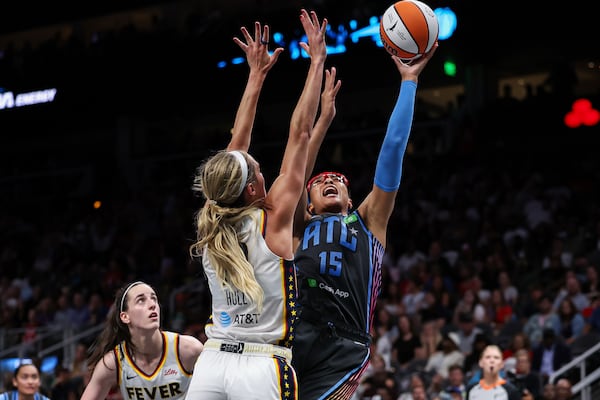 Atlanta Dream guard Allisha Gray (15) attempts a shot against Indiana Fever guard Lexie Hull, center, in the second half of an WNBA basketball game, Thursday, May, 22, 2025, in Atlanta. (AP Photo/Colin Hubbard)