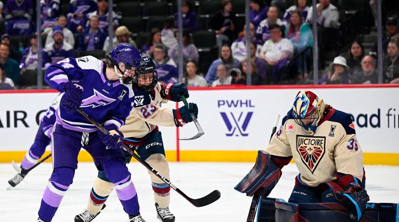 Minnesota Frost forward Abby Hustler (74) attacks the goal of Montreal Victoire goaltender Ann-Renée Desbiens (35) in the second period of a Game 4 in a PWHL hockey playoff series game, Friday, May 8, 2026, in St. Paul, Minn. (Aaron Lavinsky/Minnesota Star Tribune via AP)