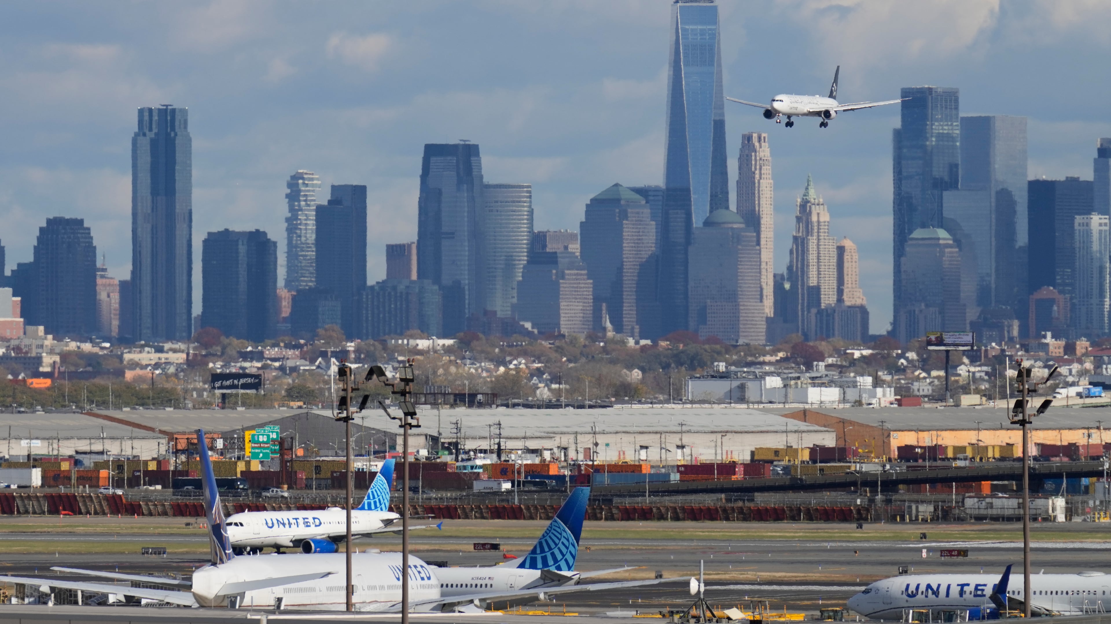 The New York City skyline is seen behind a plane approaching Newark International Airport in Newark, N.J., Thursday, Nov. 6, 2025. (AP Photo/Seth Wenig)