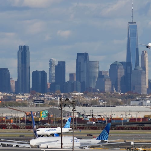 The New York City skyline is seen behind a plane approaching Newark International Airport in Newark, N.J., Thursday, Nov. 6, 2025. (AP Photo/Seth Wenig)