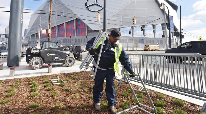 January 24, 2019 Atlanta - Javani Jaramillo, contractor, prepares to set up fences around the Mercedes-Benz Stadium near Vine City Transit Station on Thursday, January 24, 2019. HYOSUB SHIN / HSHIN@AJC.COM