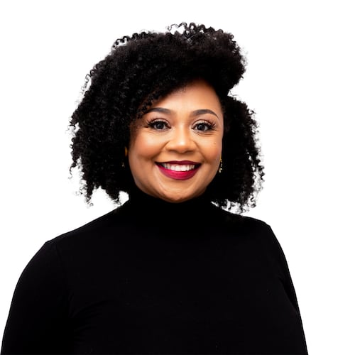 AJC wellness contributor Dr. Joy Harden Bradford poses for a headshot in a black turtleneck in front of a white backdrop