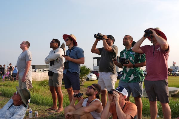 People watch as SpaceX's mega rocket Starship makes a test flight from Starbase, Texas, Tuesday, May 27, 2025. (AP Photo/Eric Gay)